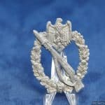 Although found commonly with some other awards, H.A. Infantry assault badges are rather scarce. This one shows some zinc pest developing as well as a missing section of wreath. The hinge and catch remain in excellent condition. Nice detail on these Aurich eagles