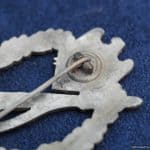 Although found commonly with some other awards, H.A. Infantry assault badges are rather scarce. This one shows some zinc pest developing as well as a missing section of wreath. The hinge and catch remain in excellent condition. Nice detail on these Aurich eagles