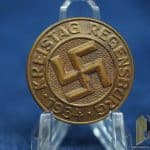 Rare. Designed to look like a party member badge but no color or enamel. Well made by c. balmberger. Solid brass. Slightly larger than a party badge at 30mm.