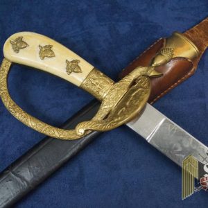 This is a fully loaded model 1059 in the Eickhorn catalogue. The triple etched blade has only the smallest signs of wear and oxidation and easily grades a 9 out of ten and is near mint in all respects. The motifs show a boar getting attacked by hunting dogs with a hunter in pursuit and a hummingbird on one side. The other side is a hunter shooting at deer and a pheasant.  The Eickhorn logo is the early double oval version which makes this blade all the more appealing in my book. The hilt and clamshell still have most of the original gilding and is a real pleasure to examine! My favorite part on these is the Eickhorn squirrel on the front! The clam shell is awesome and depicts a standing stag. The natural ivory grip plates have taken on a yellow tone, as they are un cleaned. The 6 grip acorns are all matching which is nice, since many go missing and are miss matched when replaced. The top one on each side spin a bit but this is ok as they are literally just a tack nail with an acorn head. The dagger is completed by a good condition scabbard with a crease on one side of the leather. The upper and lower fittings are matching numbers (20) and are in great shape. The original frog looks great as well and is complete with the D ring which is often broken off. The back of the frog is finished with green felt to protect the wearer's uniform. A stunning and impressive piece in hand that is sure to be a focal point of your collection! 