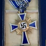 Cased mothers cross in gold by Friedrich Linden