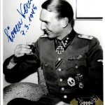 Kam, Søren Date of birth: November 2nd, 1921 (Kopenhagen, Denmark) Date of death: March 23rd, 2015 (Kempten, Germany) Service number: SS-Nr.: 456.059 // NSDAP-Nr.: Nationality: Danish Biography Promotions: - 2 September 1941 SS-Sturmmann - 30 November 1941 SS-Rottenführer - 20 April 1942 SS-Unterscharführer - 1 May 1942 SS-Junker - 1 September 1942 SS-Standartenjunker - 20 December 1942 SS-Standartenoberjunker - 30 January 1943 SS-Untersturmführer - 7 February 1945 SS-Obersturmführer Do you have more information about this person? Inform us! Eisernes Kreuz 2. Klasse Period: Second World War (1939-1945) Awarded on: September 22nd, 1941 Eisernes Kreuz 2. Klasse Infanterie-Sturmabzeichen in Silber Period: Second World War (1939-1945) Infanterie-Sturmabzeichen in Silber Verwundetenabzeichen 1939 in Schwarz Period: Second World War (1939-1945) Verwundetenabzeichen 1939 in Schwarz Medaille "Winterschlacht im Osten 1941/42" (Ostmedaille) Period: Second World War (1939-1945) Awarded on: 1942 Medaille Eisernes Kreuz 1. Klasse Period: Second World War (1939-1945) Awarded on: April 20th, 1944 Eisernes Kreuz 1. Klasse Nahkampfspange in Bronze Period: Second World War (1939-1945) Awarded on: 1944 Nahkampfspange in Bronze Verwundetenabzeichen 1939 in Silber Period: Second World War (1939-1945) Awarded on: 1944 Verwundetenabzeichen 1939 in Silber Ritterkreuz des Eisernen Kreuzes Period: Second World War (1939-1945) Rank: SS-Untersturmführer (2nd Lieutenant) Unit: Führer, 1. Kompanie, SS-Panzer-Grenadier-Regiment 9 "Germania", 5. SS-Panzer-Division "Wiking", IV. SS-Panzerkorps, Heeresgruppe Süd Awarded on: February 7th, 1945 Kam’s Knight’s Cross recommendation reads as follows… “During the hard defensive battle against overwhelming Soviet forces between the Vistula and Bug rivers (north of Warsaw), which began on the 10.10.1944 and continues to this day, SS-Untersturmführer Kam once again distinguished himself through incredible courageous and exceptional steadfastness. On the 26.10.1944 the enemy attacked the positions of Kam’s Kompanie (which lay 2.5-3 km northwest of Wieliscew) following a heavy preparatory barrage by artillery, mortars and ground attack planes. The Soviets wished to take the decisive Hill 86 (which was of massive importance for the Division’s continuation of the defensive battle) at any cost. The defensive positions on Hill 86 (which rose as a single sandy height above the surrounding area) were completely smashed by the enemy drumfire. Kam’s Kompanie suffered substantial losses. By attacking from the east and north, and with heavy fire support from the domineering north bank of the Bug, the enemy was eventually able to capture the hotly contested Hill 86. Following an immediate counterthrust that Kam personally led on his own initiative, the enemy was thrown off the hill. In the meantime however the Soviets had also managed to penetrate into the forest west of the hill. A bitter fight erupted which saw the hill lost to the enemy once again. Over a period of 6 hours Kam and the remains of his Kompanie counterattacked the hill a total of 5 times, each time taking it and then losing it shortly afterwards. This continued until 15:00, when they were able to finally gain a firm control over it. With his few remaining soldiers Kam defended this place against all enemy attacks, which by now were also coming from the hill to the west. The fire of the enemy heavy weapons, especially on the commanding north bank of the Bug, increased noticeably. Kam stood his ground until the fighting ceased in the evening, by which time his force had been reduced to 7 men. It was only the boldly conducted counterthrusts and the death-defying, fanatical resistance of SS-Untersturmführer Kam and his men that made it possible to prevent the Soviets from taking control of Hill 86 and from here collapse the entire defensive front of the Regiment. Kam is a Germanic volunteer/Dane, and the student of an SS-Obersturmbannführer from Schalburg. This dashing and brave SS leader has encouraged Germanic volunteers through his invigorating words and personal example in this time of momentary political crisis. Indicative of his determination is that he flew into the Cherkassy pocket on the 09.02.1944 despite orders to the contrary, and in the fighting which followed he continued to lead his Zug during the breakout of the 17.02.1944 despite being badly wounded in the head. The Regiment considers SS-Untersturmführer Kam as particularly worthy of being decorated with the Knight’s Cross to the Iron Cross.” Ritterkreuz des Eisernen Kreuzes Nahkampfspange in Silber Period: Second World War (1939-1945) Awarded on: 1945 Nahkampfspange in Silber