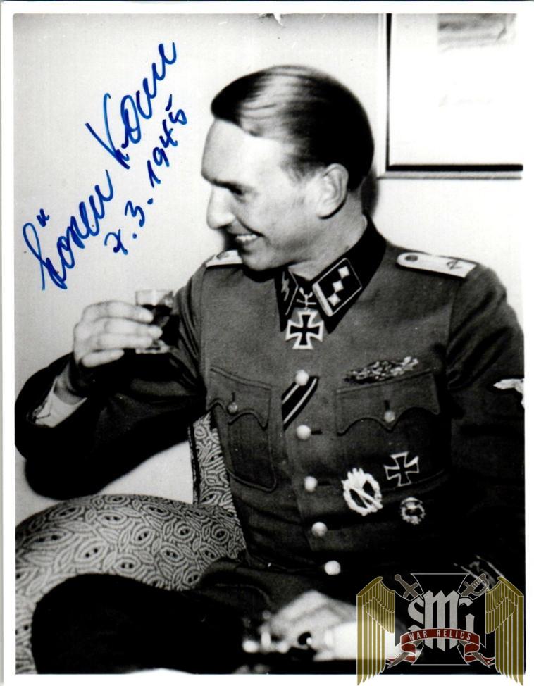 Kam, Søren Date of birth: November 2nd, 1921 (Kopenhagen, Denmark) Date of death: March 23rd, 2015 (Kempten, Germany) Service number: SS-Nr.: 456.059 // NSDAP-Nr.: Nationality: Danish Biography Promotions: - 2 September 1941 SS-Sturmmann - 30 November 1941 SS-Rottenführer - 20 April 1942 SS-Unterscharführer - 1 May 1942 SS-Junker - 1 September 1942 SS-Standartenjunker - 20 December 1942 SS-Standartenoberjunker - 30 January 1943 SS-Untersturmführer - 7 February 1945 SS-Obersturmführer Do you have more information about this person? Inform us! Eisernes Kreuz 2. Klasse Period: Second World War (1939-1945) Awarded on: September 22nd, 1941 Eisernes Kreuz 2. Klasse Infanterie-Sturmabzeichen in Silber Period: Second World War (1939-1945) Infanterie-Sturmabzeichen in Silber Verwundetenabzeichen 1939 in Schwarz Period: Second World War (1939-1945) Verwundetenabzeichen 1939 in Schwarz Medaille "Winterschlacht im Osten 1941/42" (Ostmedaille) Period: Second World War (1939-1945) Awarded on: 1942 Medaille Eisernes Kreuz 1. Klasse Period: Second World War (1939-1945) Awarded on: April 20th, 1944 Eisernes Kreuz 1. Klasse Nahkampfspange in Bronze Period: Second World War (1939-1945) Awarded on: 1944 Nahkampfspange in Bronze Verwundetenabzeichen 1939 in Silber Period: Second World War (1939-1945) Awarded on: 1944 Verwundetenabzeichen 1939 in Silber Ritterkreuz des Eisernen Kreuzes Period: Second World War (1939-1945) Rank: SS-Untersturmführer (2nd Lieutenant) Unit: Führer, 1. Kompanie, SS-Panzer-Grenadier-Regiment 9 "Germania", 5. SS-Panzer-Division "Wiking", IV. SS-Panzerkorps, Heeresgruppe Süd Awarded on: February 7th, 1945 Kam’s Knight’s Cross recommendation reads as follows… “During the hard defensive battle against overwhelming Soviet forces between the Vistula and Bug rivers (north of Warsaw), which began on the 10.10.1944 and continues to this day, SS-Untersturmführer Kam once again distinguished himself through incredible courageous and exceptional steadfastness. On the 26.10.1944 the enemy attacked the positions of Kam’s Kompanie (which lay 2.5-3 km northwest of Wieliscew) following a heavy preparatory barrage by artillery, mortars and ground attack planes. The Soviets wished to take the decisive Hill 86 (which was of massive importance for the Division’s continuation of the defensive battle) at any cost. The defensive positions on Hill 86 (which rose as a single sandy height above the surrounding area) were completely smashed by the enemy drumfire. Kam’s Kompanie suffered substantial losses. By attacking from the east and north, and with heavy fire support from the domineering north bank of the Bug, the enemy was eventually able to capture the hotly contested Hill 86. Following an immediate counterthrust that Kam personally led on his own initiative, the enemy was thrown off the hill. In the meantime however the Soviets had also managed to penetrate into the forest west of the hill. A bitter fight erupted which saw the hill lost to the enemy once again. Over a period of 6 hours Kam and the remains of his Kompanie counterattacked the hill a total of 5 times, each time taking it and then losing it shortly afterwards. This continued until 15:00, when they were able to finally gain a firm control over it. With his few remaining soldiers Kam defended this place against all enemy attacks, which by now were also coming from the hill to the west. The fire of the enemy heavy weapons, especially on the commanding north bank of the Bug, increased noticeably. Kam stood his ground until the fighting ceased in the evening, by which time his force had been reduced to 7 men. It was only the boldly conducted counterthrusts and the death-defying, fanatical resistance of SS-Untersturmführer Kam and his men that made it possible to prevent the Soviets from taking control of Hill 86 and from here collapse the entire defensive front of the Regiment. Kam is a Germanic volunteer/Dane, and the student of an SS-Obersturmbannführer from Schalburg. This dashing and brave SS leader has encouraged Germanic volunteers through his invigorating words and personal example in this time of momentary political crisis. Indicative of his determination is that he flew into the Cherkassy pocket on the 09.02.1944 despite orders to the contrary, and in the fighting which followed he continued to lead his Zug during the breakout of the 17.02.1944 despite being badly wounded in the head. The Regiment considers SS-Untersturmführer Kam as particularly worthy of being decorated with the Knight’s Cross to the Iron Cross.” Ritterkreuz des Eisernen Kreuzes Nahkampfspange in Silber Period: Second World War (1939-1945) Awarded on: 1945 Nahkampfspange in Silber