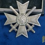 Cased First Class War Merit Cross w/repair with Swords by Deschler Marked “1” in Tombak